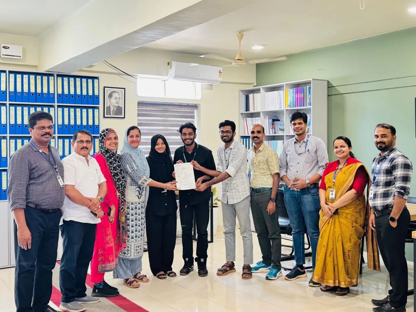 Group photo of the DeVoc team marking the signing of a Memorandum of Understanding with Farook College (Autonomous), with participants standing together and holding the signed agreement.