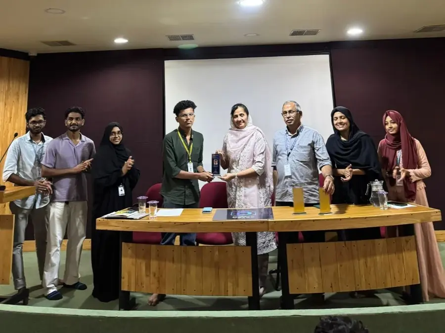 Group photo of student recognition ceremony with mementos for recent hackathon participation