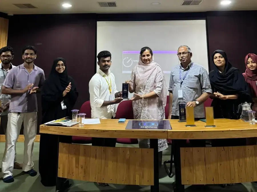Group photo of student recognition ceremony with mementos for recent hackathon participation
